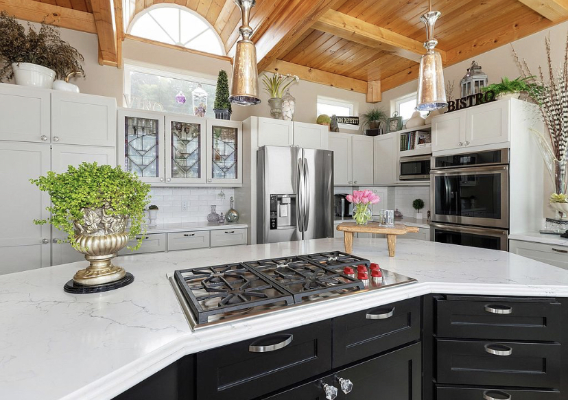 Finished kitchen with vaulted wood ceiling and quartz island